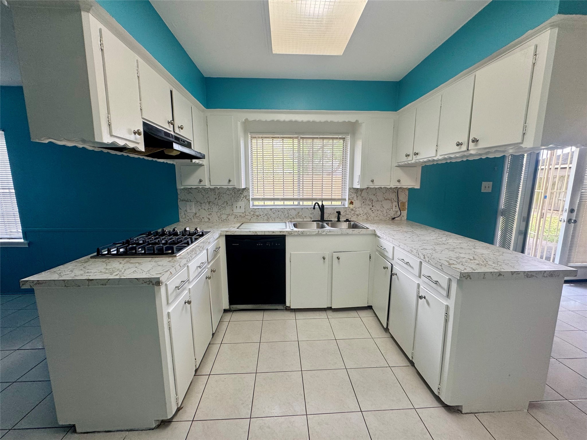 8418 Hazen Street Houston, TX 77036 - Photo 5 of 25 a kitchen with a stove sink and cabinets