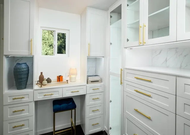 a kitchen with a stove cabinets and a window