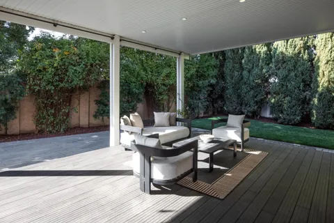a view of a patio with wooden floor and outdoor seating