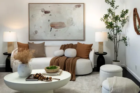 a living room with furniture and a lamp