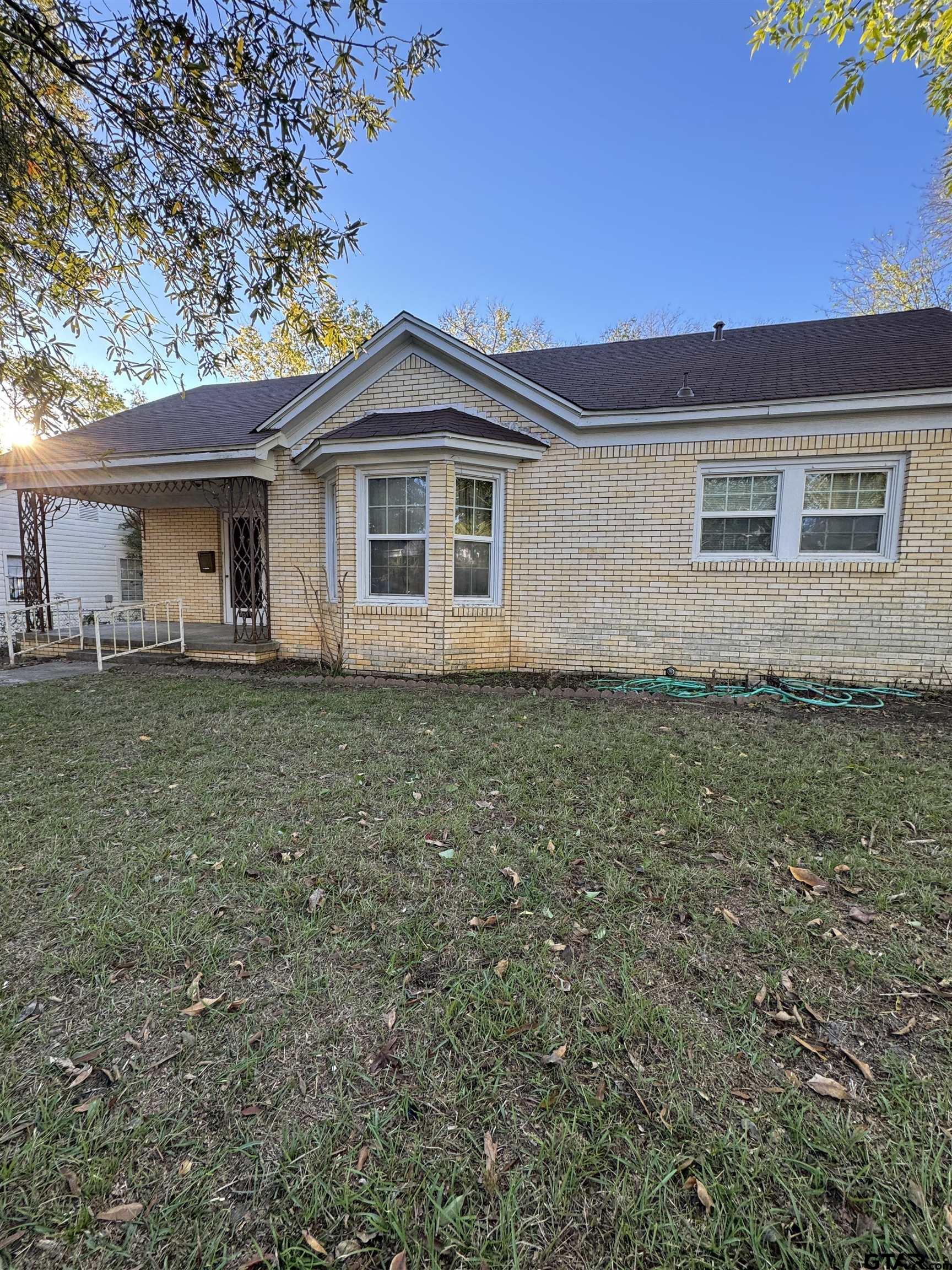 1014 Mockingbird Lane Tyler, TX 75701 - Photo 2 of 6 a front view of house with yard and trees around