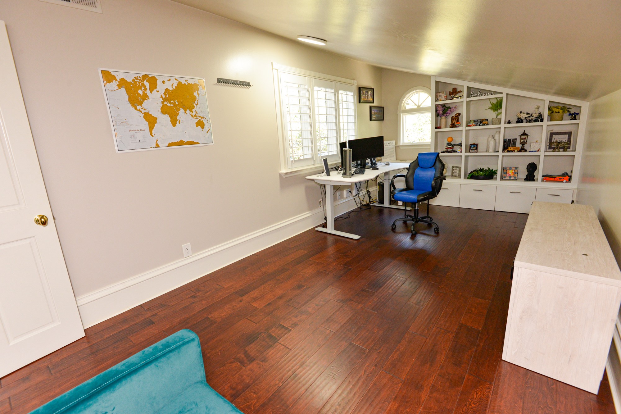 10710 D-K Ranch Road Austin, TX 78759 - Photo 24 of 34 Rich hardwood floors complement built-in shelving, creating a productive home office environment.