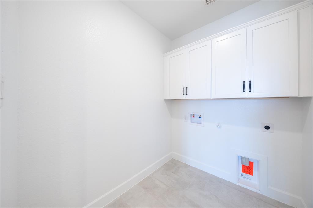 2715 Triumph Court Heath, TX 75126 - Photo 17 of 30 a utility room with cabinets