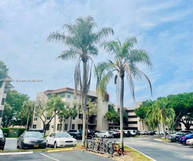 a row of palm trees and swimming pool in the backyard of a house