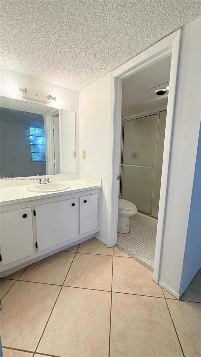 1811 Sabal Palm Drive, Unit 208 Davie, FL 33324 - Photo 21 of 32 a bathroom with a double vanity sink mirror and toilet