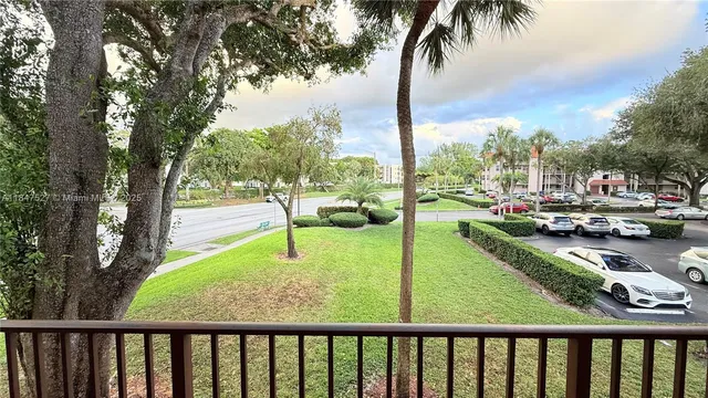 a view of a swimming pool with a patio and a yard