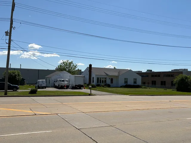 a view of a house with a big yard and potted plants