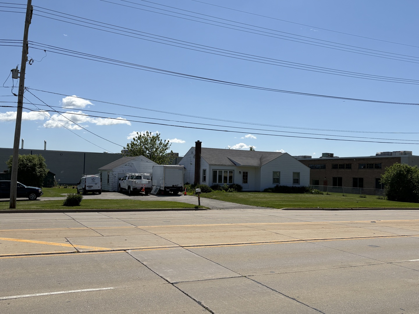 1033 Wheeling Road Wheeling, IL 60090 - Photo 2 of 8 a view of a house with a big yard and potted plants