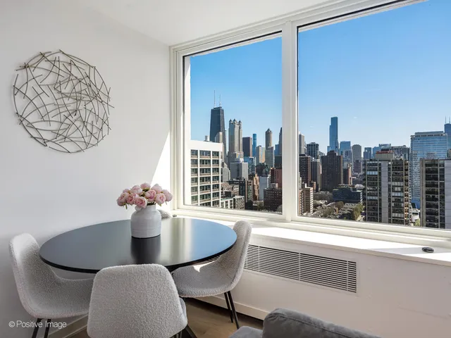 a view of a dining room with furniture and window