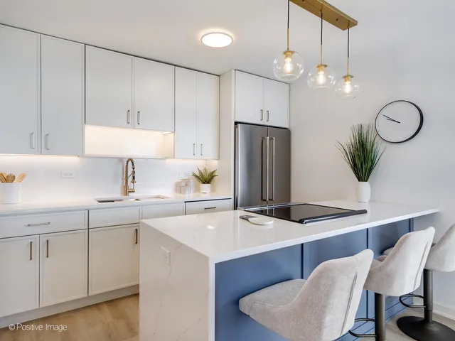 a kitchen with a table chairs sink and cabinets