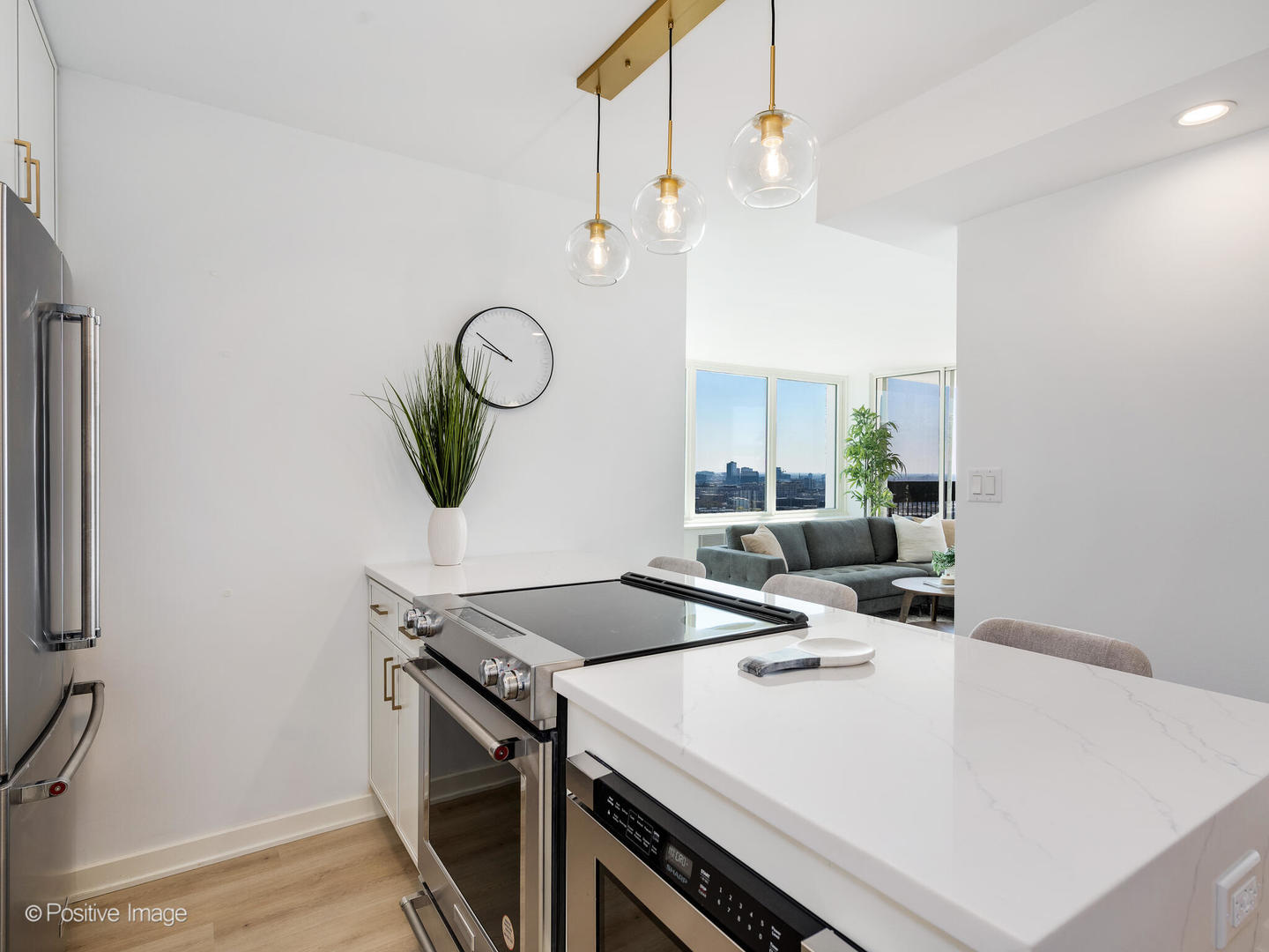 1455 North Sandburg Terrace, Unit 2901B Chicago, IL 60610 - Photo 15 of 42 a view of a kitchen island with furniture and wooden floor