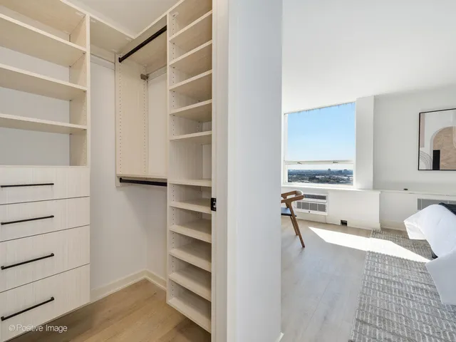 a view of a bedroom with a furniture and closet