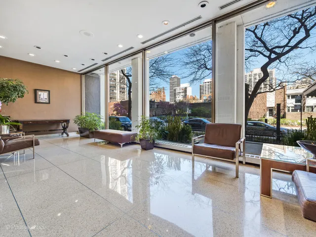 a lobby with furniture and floor to ceiling window