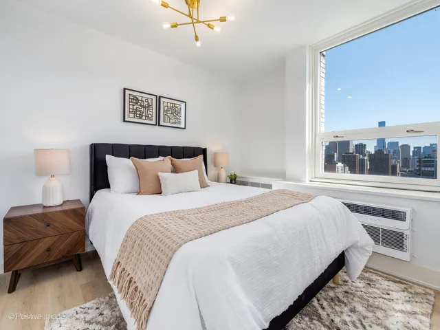 a bedroom with a large bed and a window