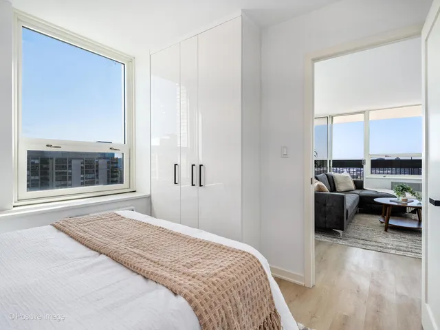 a bedroom with a bed and a large window