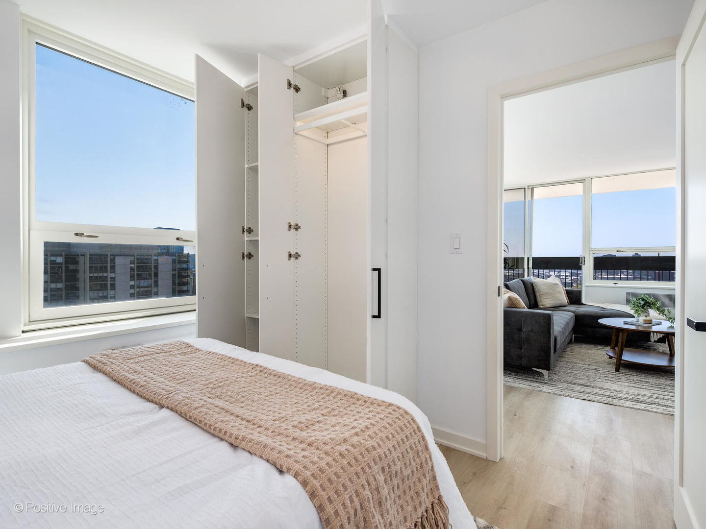 1455 North Sandburg Terrace, Unit 2901B Chicago, IL 60610 - Photo 23 of 42 a bedroom with a bed and glass window