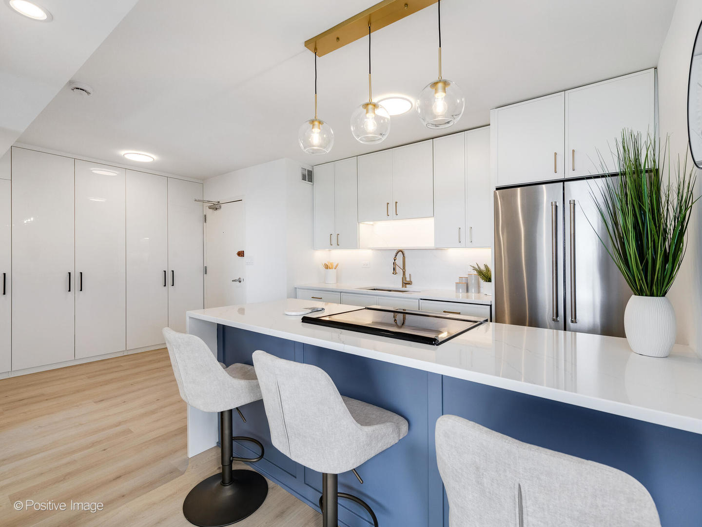1455 North Sandburg Terrace, Unit 2901B Chicago, IL 60610 - Photo 3 of 42 a kitchen with stainless steel appliances a dining table chairs and wooden floor