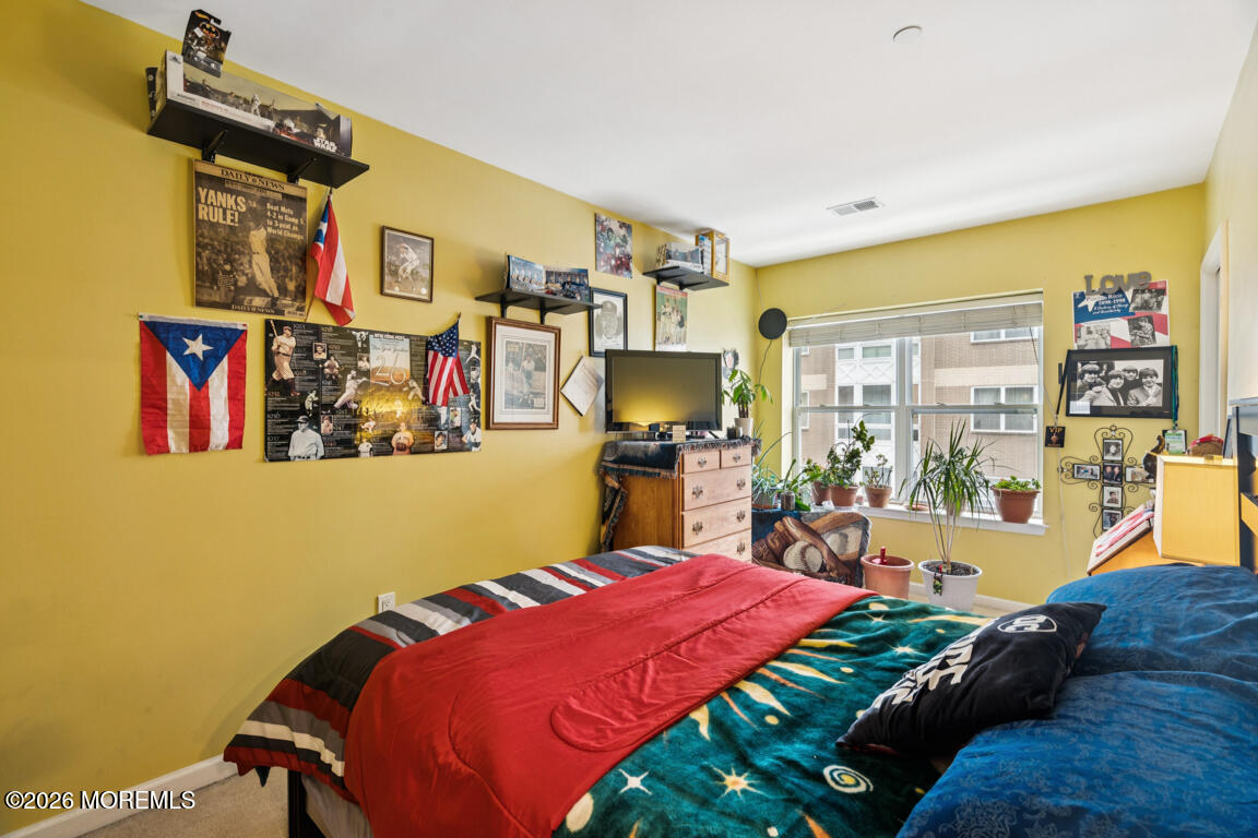 368 Rector Street, Unit 419 Perth Amboy, NJ 08861 - Photo 5 of 14 a bed room with a bed and a television