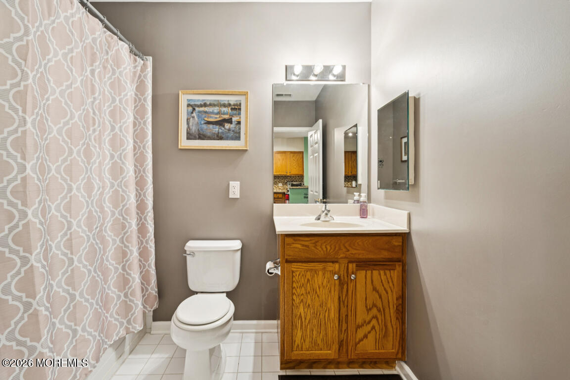 368 Rector Street, Unit 419 Perth Amboy, NJ 08861 - Photo 7 of 14 a bathroom with a toilet sink and mirror