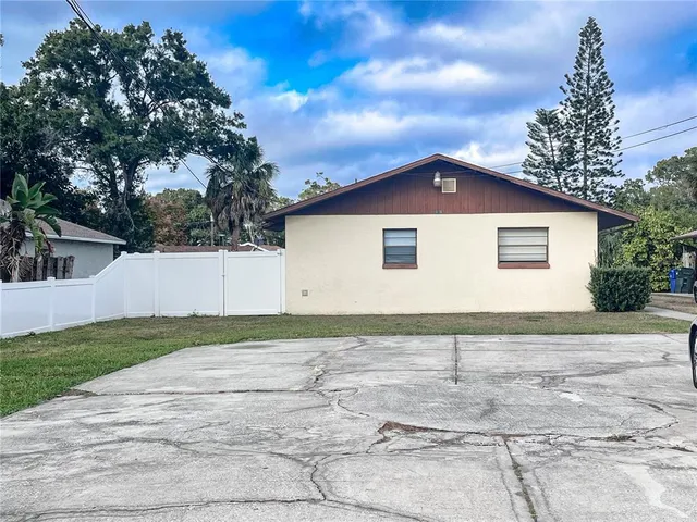 a view of backyard of house with trees