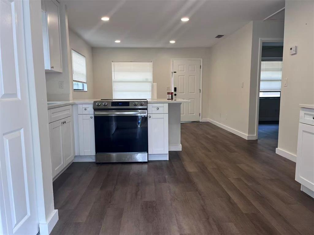 1016 9th Avenue Northwest, Unit B Largo, FL 33770 - Photo 5 of 11 a kitchen with stainless steel appliances granite countertop a stove and a refrigerator