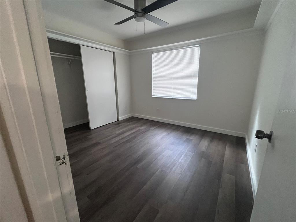 1016 9th Avenue Northwest, Unit B Largo, FL 33770 - Photo 8 of 11 an empty room with wooden floor and a window