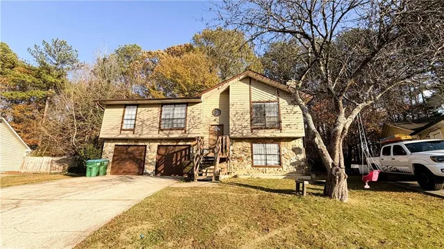 a front view of a house with a yard and garage