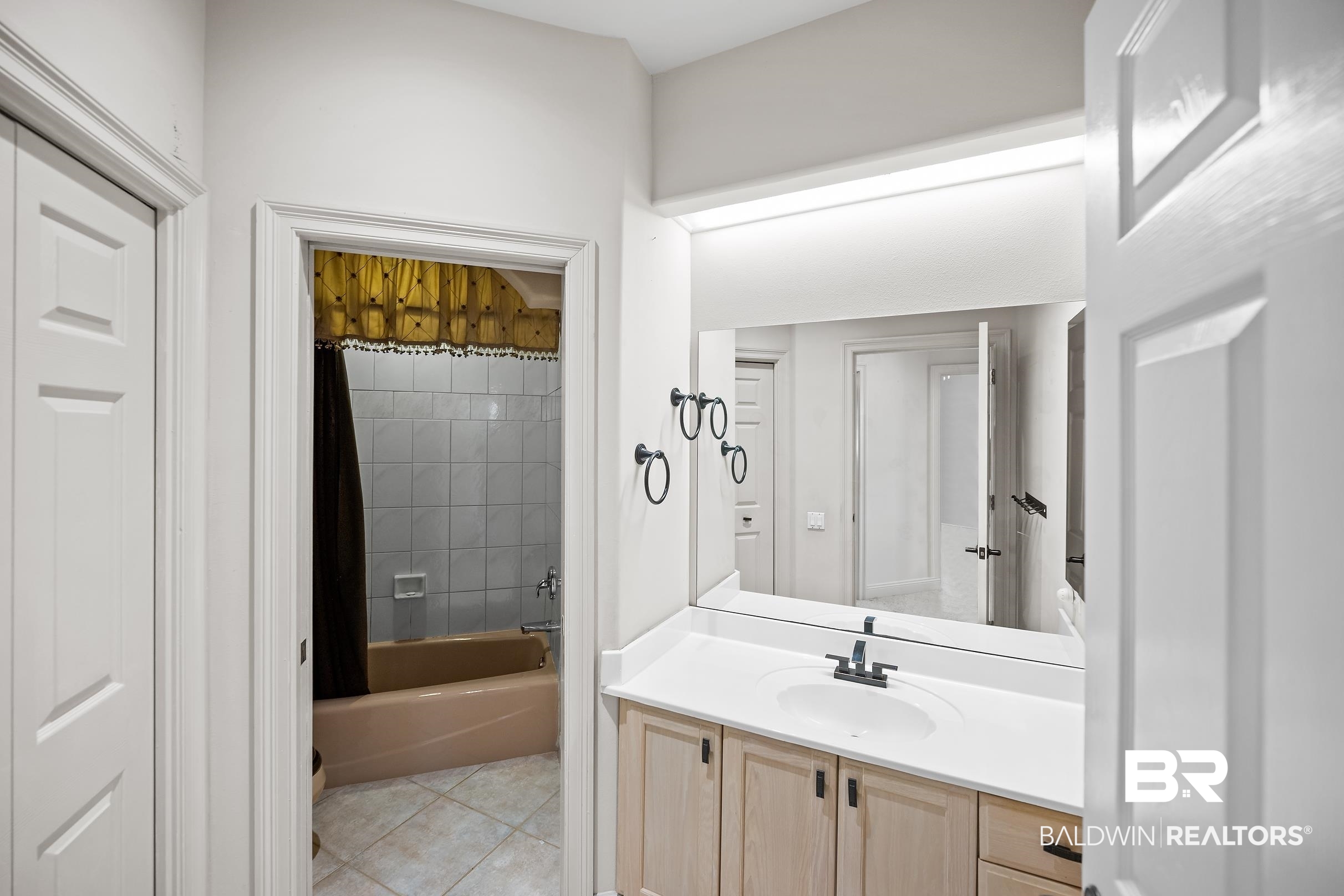 8591 Bay Harbor Road Elberta, AL 36530 - Photo 37 of 56 Full bath with shower / tub combo, vanity, and light tile patterned floors