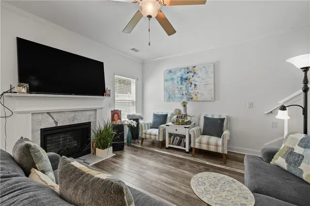 a living room with furniture a flat screen tv and a fireplace