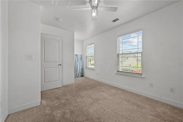 a bedroom with a bed and ceiling fan
