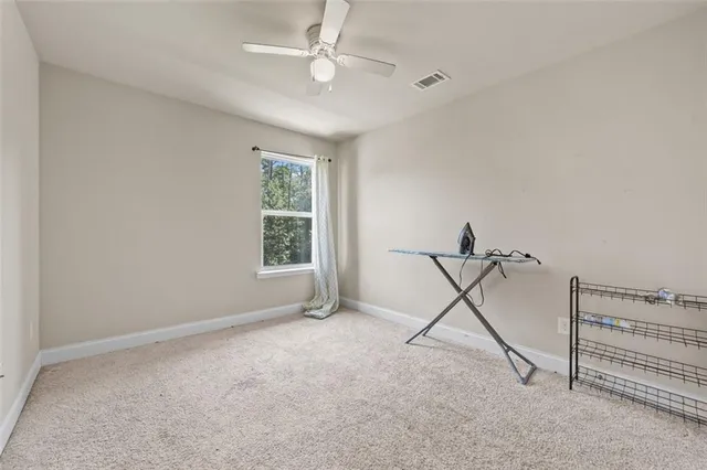 a bathroom with a sink vanity mirror and toilet