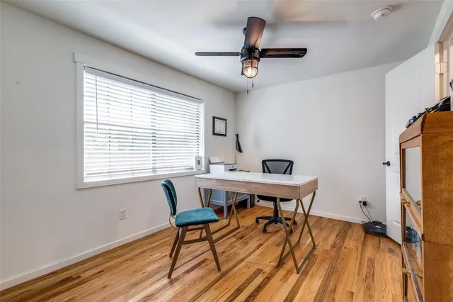 a view of a workspace with furniture and a window