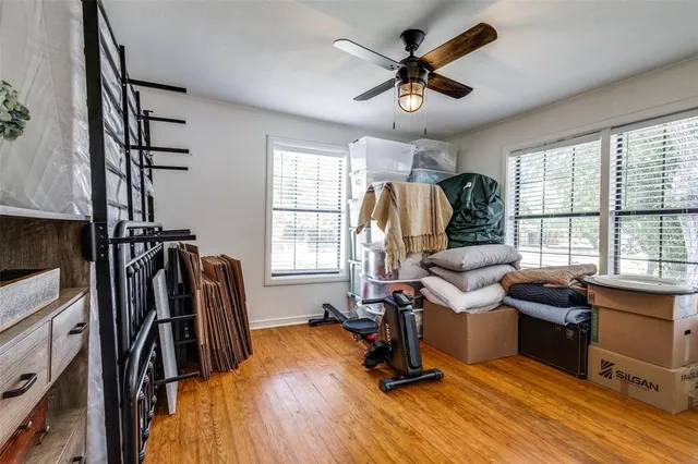 a view of a livingroom with workspace and a window