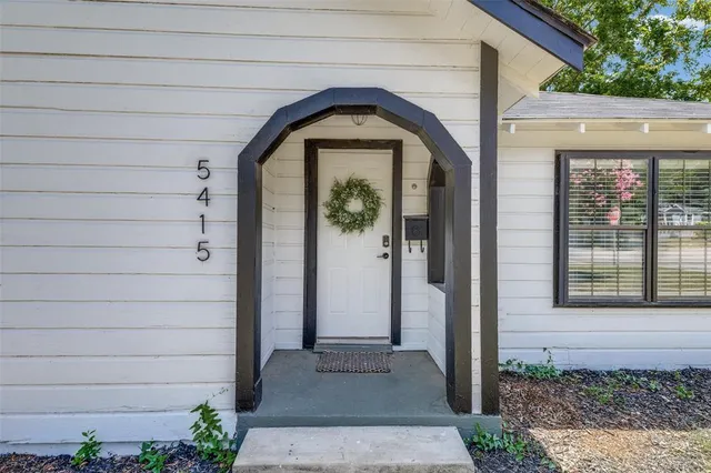 a front view of a house with a glass door