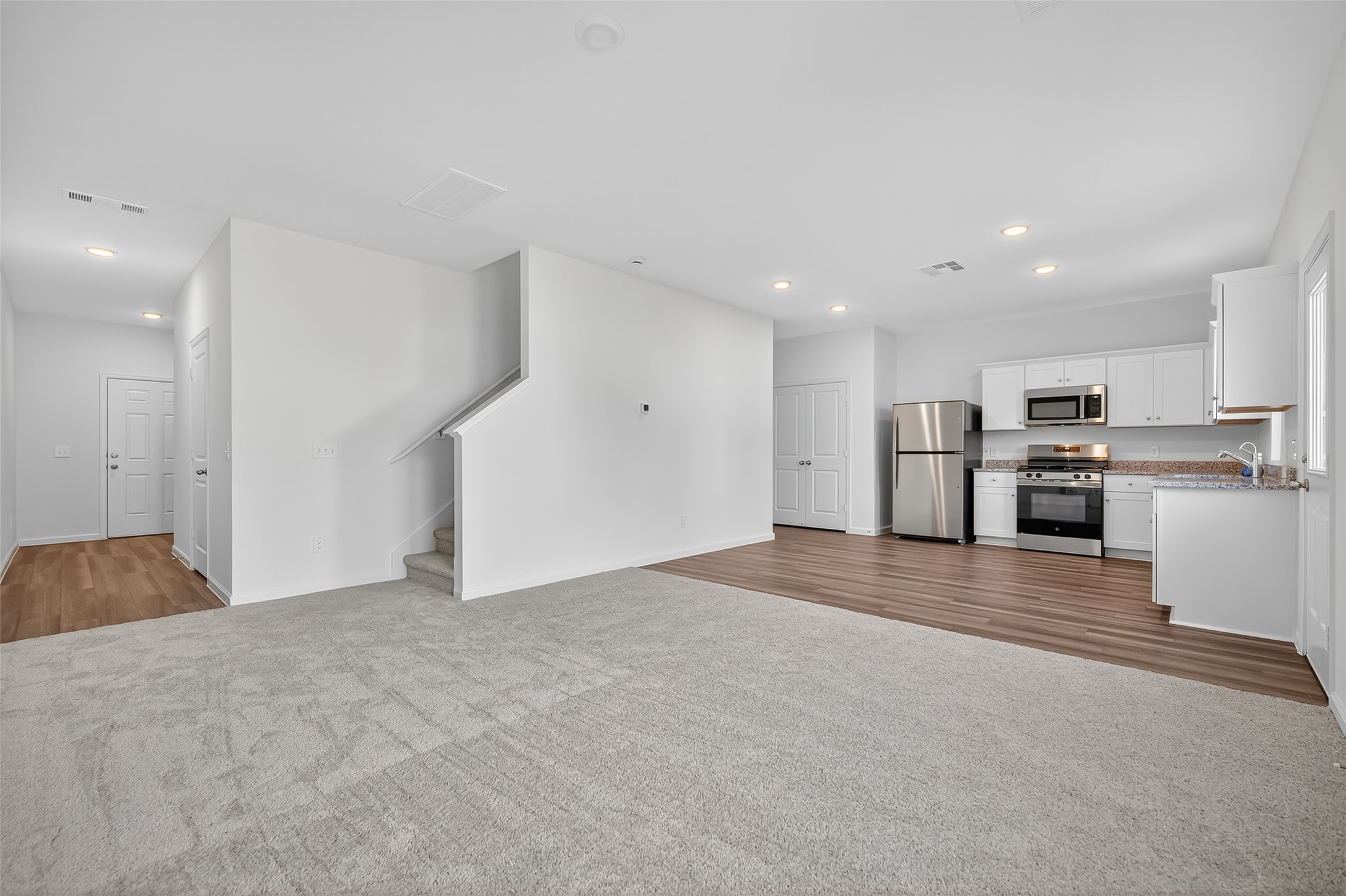18752 Lucas Michael Way New Caney, TX 77357 - Photo 3 of 19 a view of a kitchen with a sink stove refrigerator and cabinets
