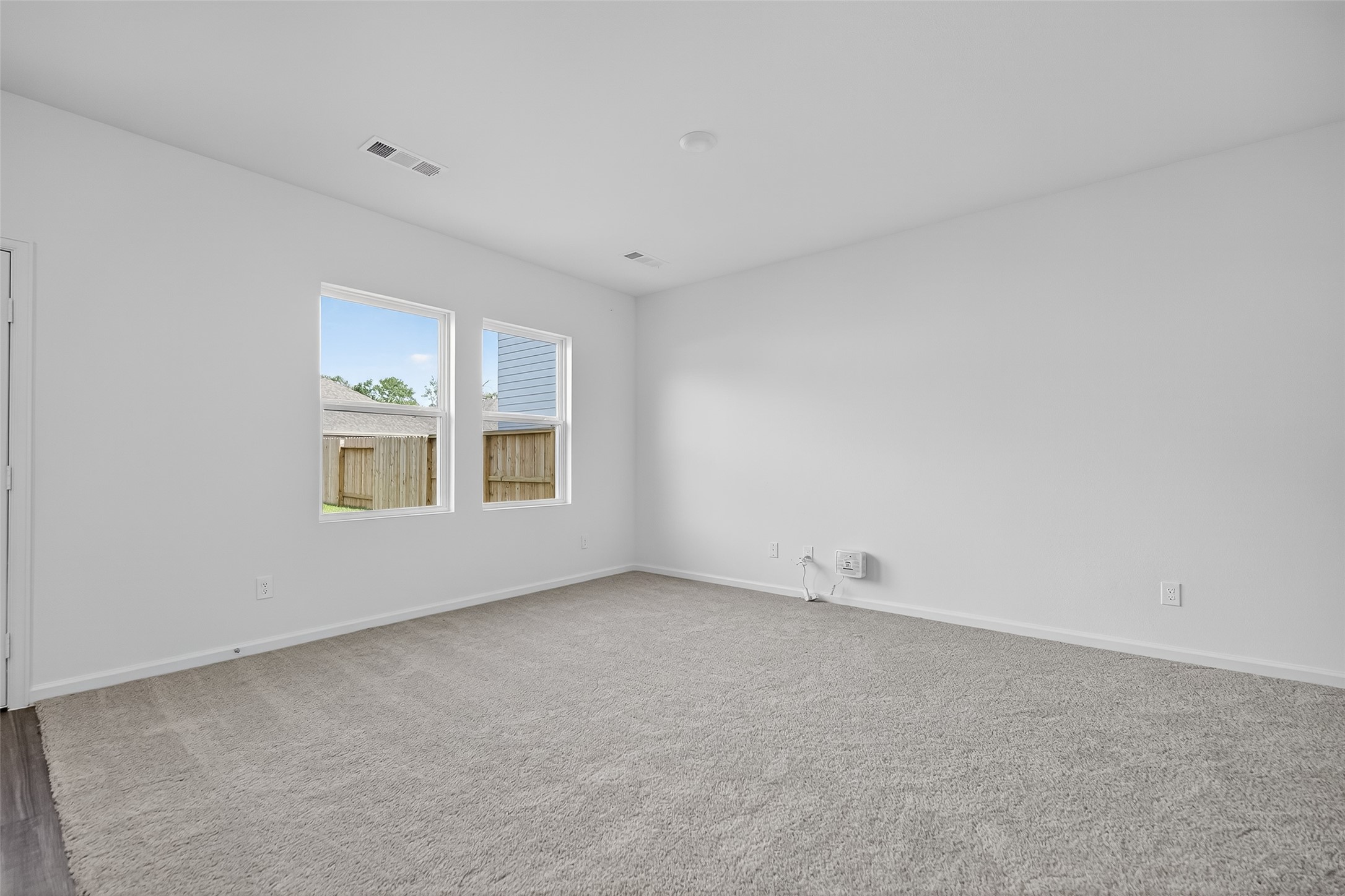 18752 Lucas Michael Way New Caney, TX 77357 - Photo 6 of 19 a view of an empty room with a window
