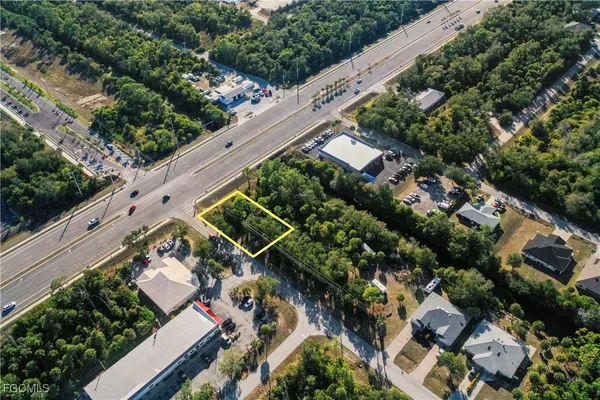an aerial view of multiple houses with yard