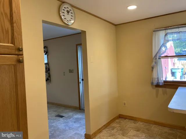 a view of a refrigerator in kitchen and a sink