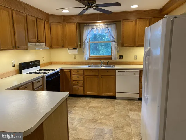 a kitchen with a sink cabinets and a wooden floor
