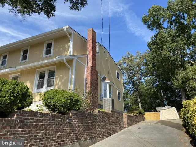 a front view of house with a garden