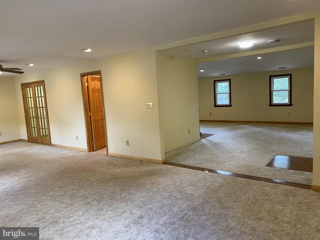 a view of backyard with tub and trees in the background