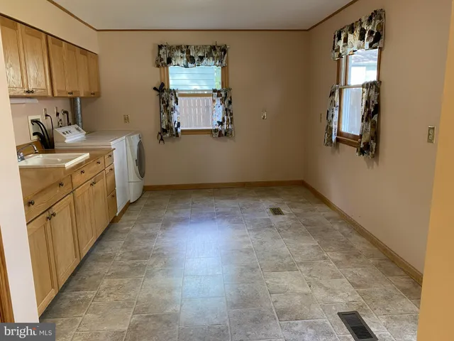 a utility room with sink dryer and washer
