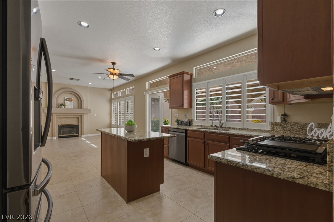 29 Olive Tree Henderson, NV 89074 - Photo 12 of 60 This kitchen seamlessly connects to a living space, featuring practical appliances and elegant finishes.