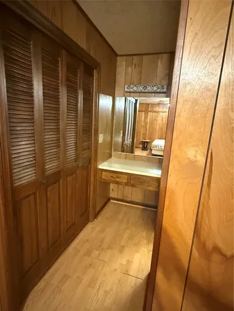 a bathroom with a sink and mirror with bathtub