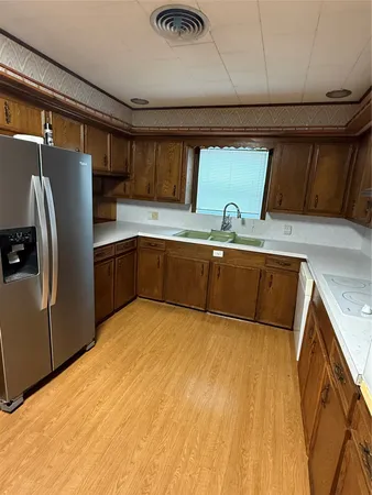 a kitchen with stainless steel appliances granite countertop a sink and a refrigerator