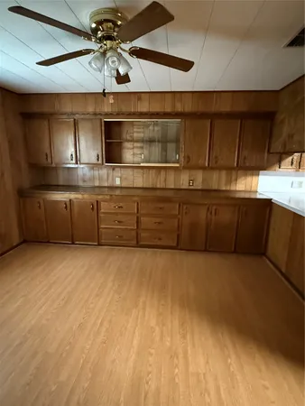 a kitchen with cabinets and window