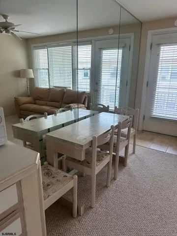 a dining room with furniture and window