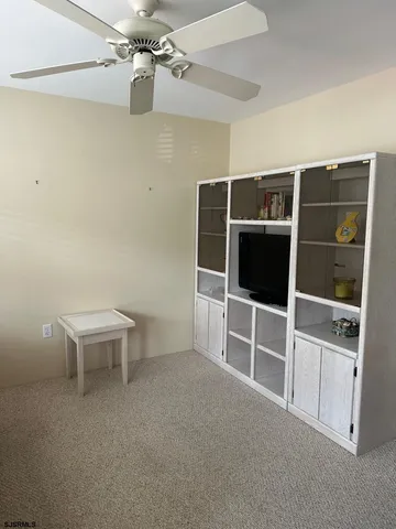 a view of a livingroom with furniture and staircase
