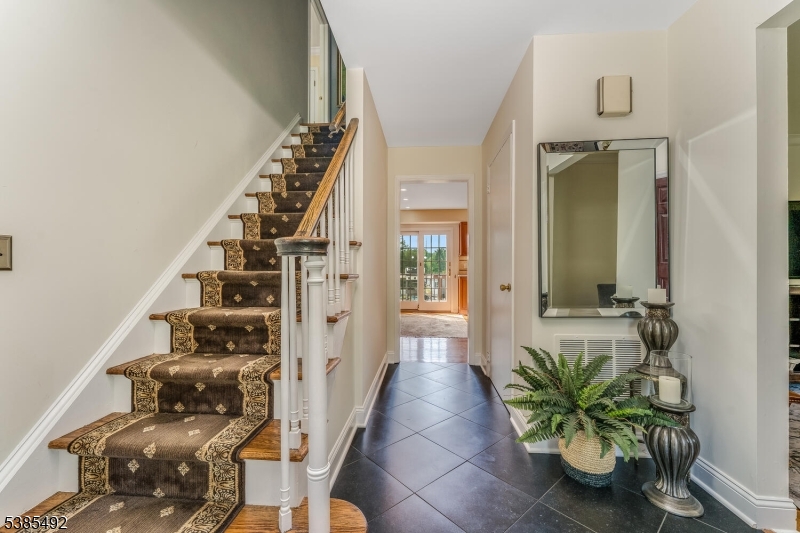 48 West Main Street Mendham, NJ 07945 - Photo 2 of 28 a view of a hallway with wooden floor and front door