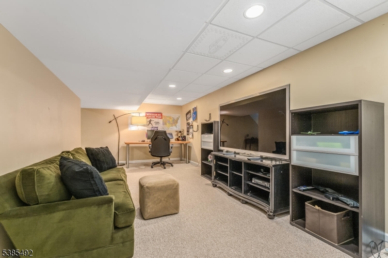 48 West Main Street Mendham, NJ 07945 - Photo 25 of 28 a living room with furniture and a flat screen tv
